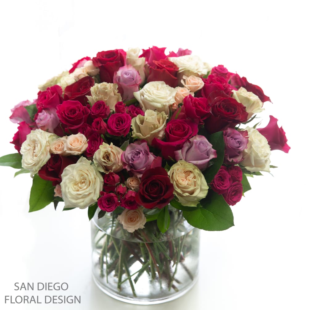 A grand arrangement filled with Ecuadorian roses in shades of pink, lavender