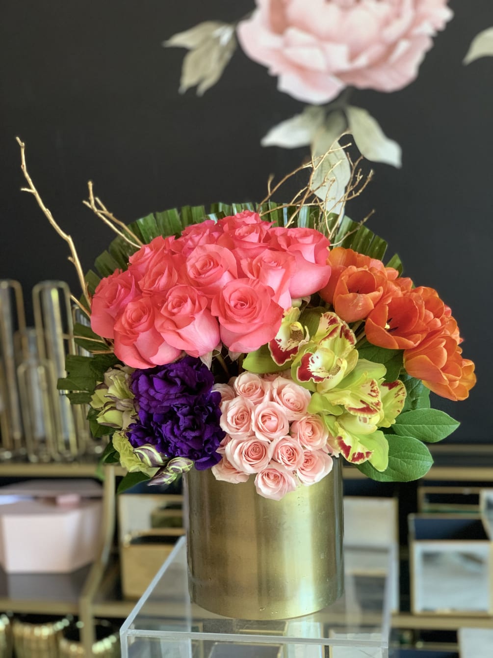 This vibrant arrangement is packed with lush florals in every color. All