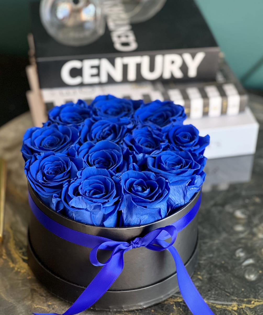 Forever Roses, that last up to 3 years. 
Royal Blue preserved roses