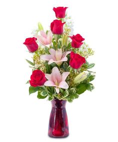 A generous number of roses and Asiatic lilies make a tall and