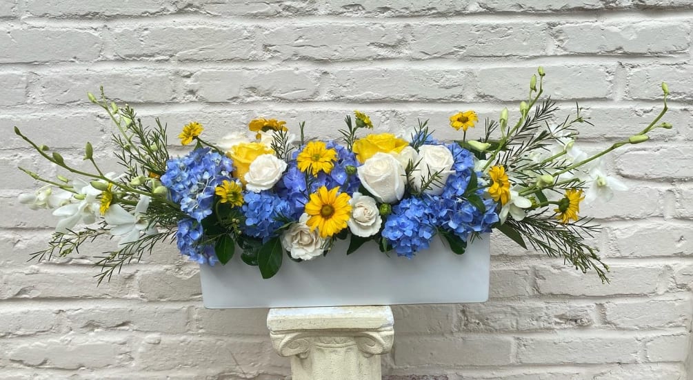 Arrangement of blue hydrangea  and white roses, daisies, accented with fresh