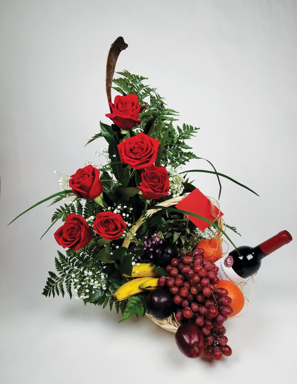 Beautiful basket of six roses, playing fruits, (grapes, bananas, oranges, plums) and