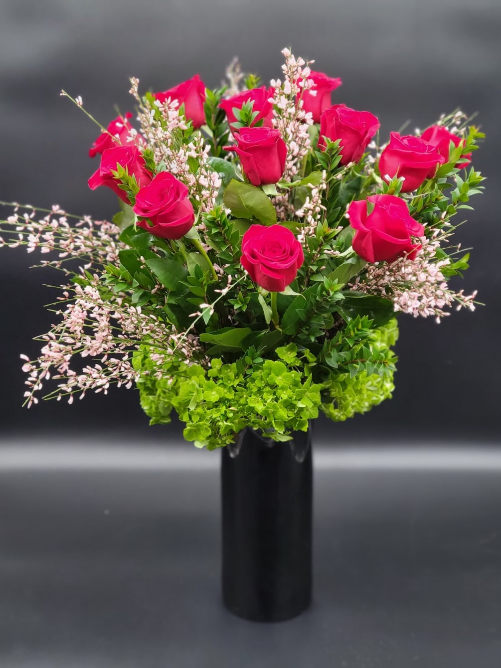 Glass vase will display a burst of exquisite pink roses sure to