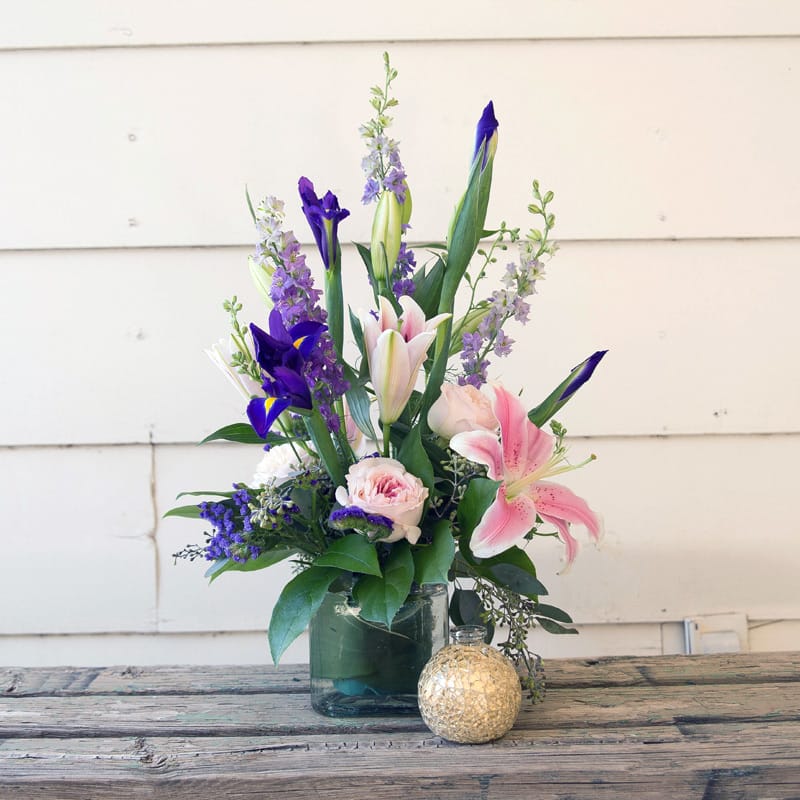 Leaf Lined Cube with Soft pink lilies, Roses, Purple Iris and Larkspur.