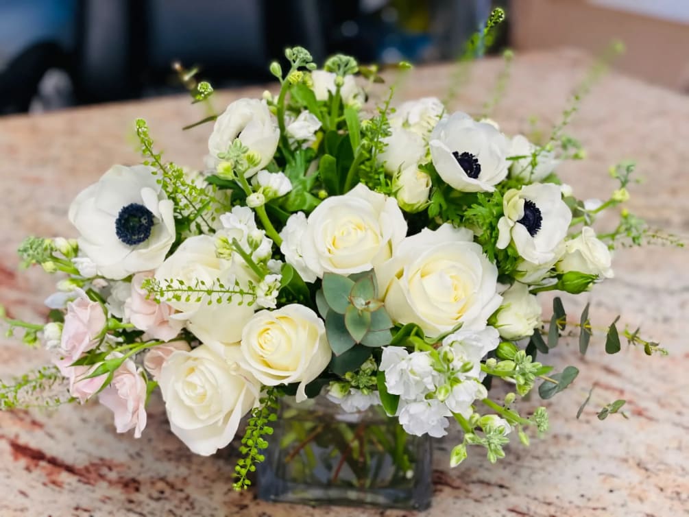 This bouquet is mixed of green and white tones includes, roses, spray