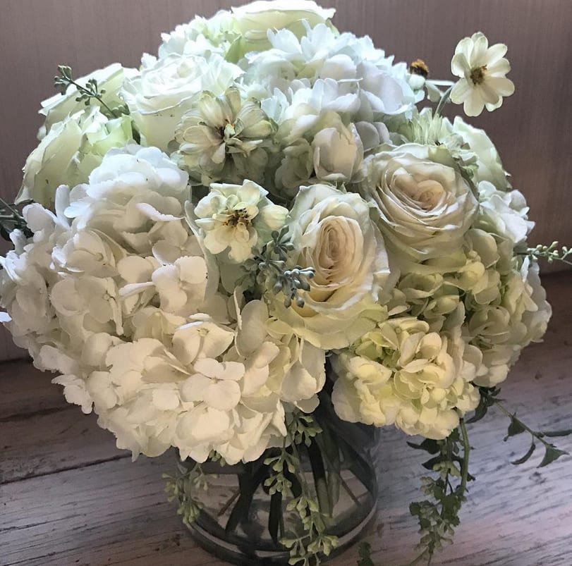 Lovely clean and elegant arrangement of white hydrangeas, white roses and scented