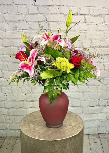Beautiful shades of red and green make this arrangement a scarlet splendor.