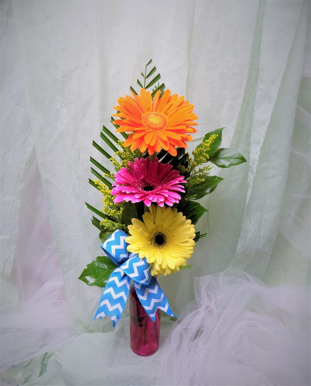 A colorful Gerber Daisy arrangement that celebrates all of life&#039;s joy!