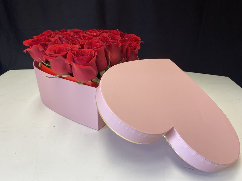 Freshly picked red roses arranged in a heart shape box.
