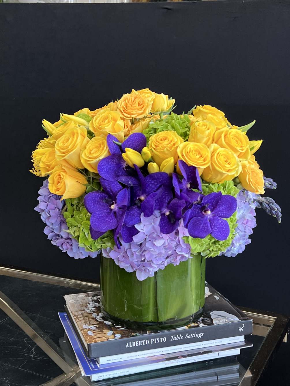 A vibrant arrangement in a sleek cylinder container, overflowing with the most
