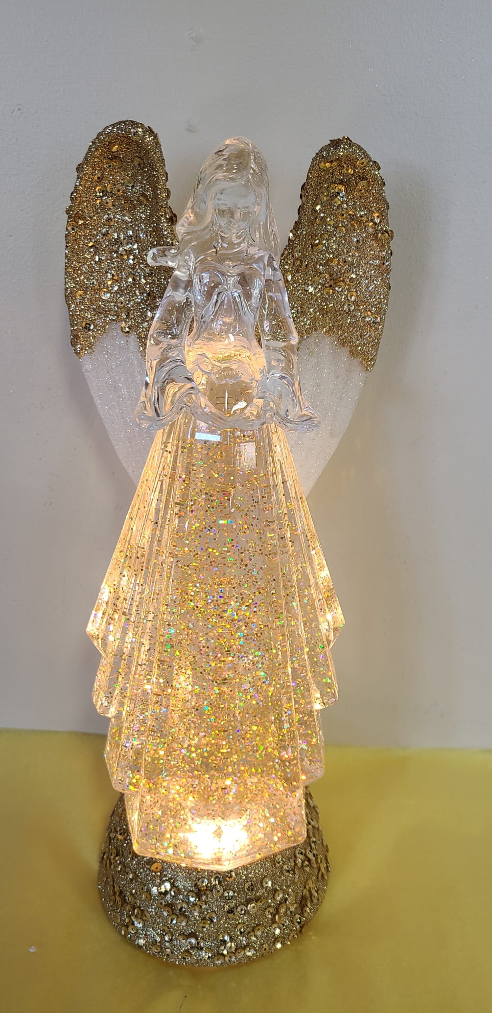 This Gold Angel lights up with a motion of Glitter