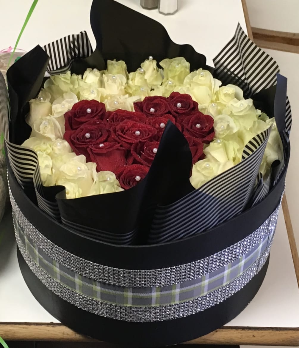 50-100 roses in  any color in a decorative hat box. You