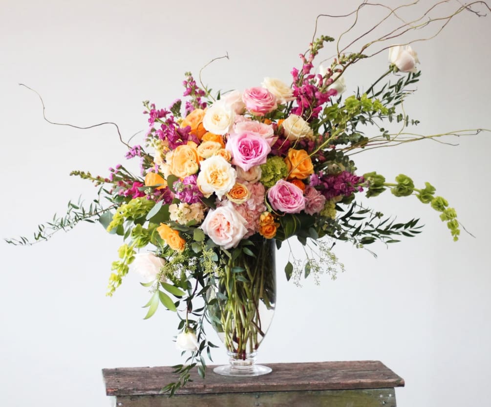This stunning collection of roses, hydrangea, seasonal blooms, textures and willow will
