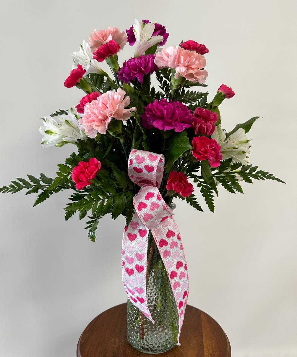 A mixed arrangement with heart insert and Heart ribbon.  Ribbon style