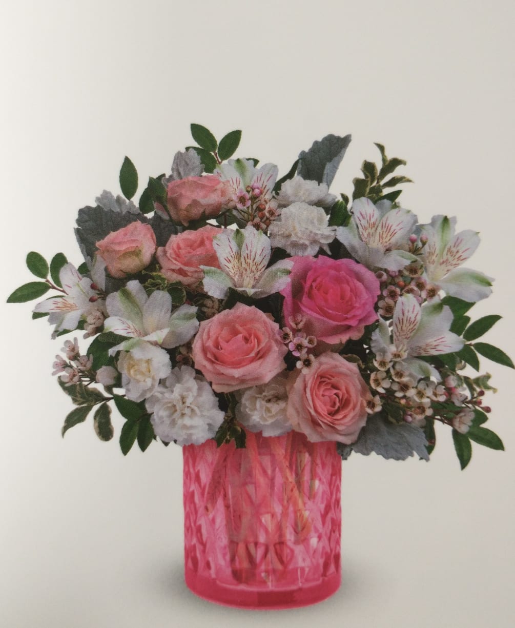 Pretty pink flowers with white accent flowers in a beautiful pink glass