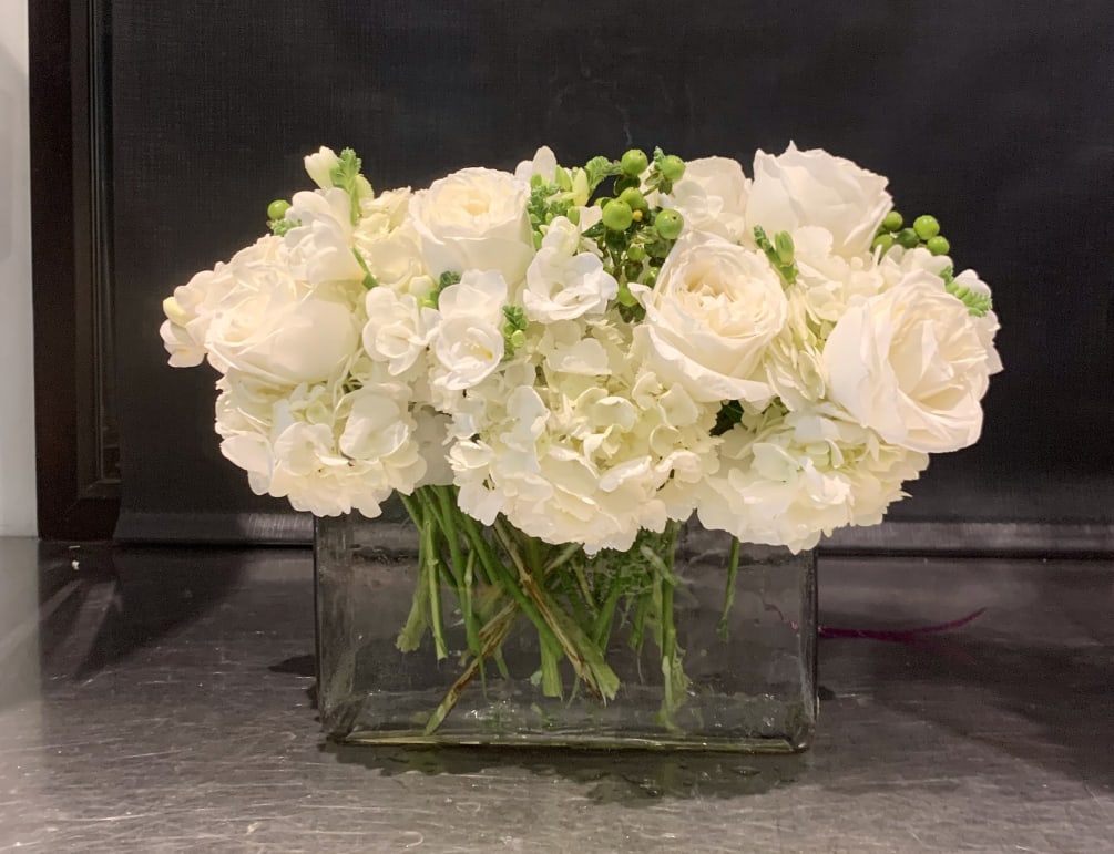 Custom arrangement of white roses, white freesia, green hypericum berries &amp; white