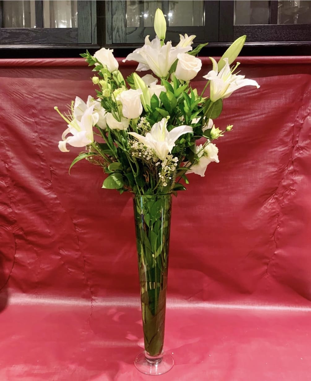 Custom arrangement of Casablanca lilies, white roses, white lisianthus &amp; greens in