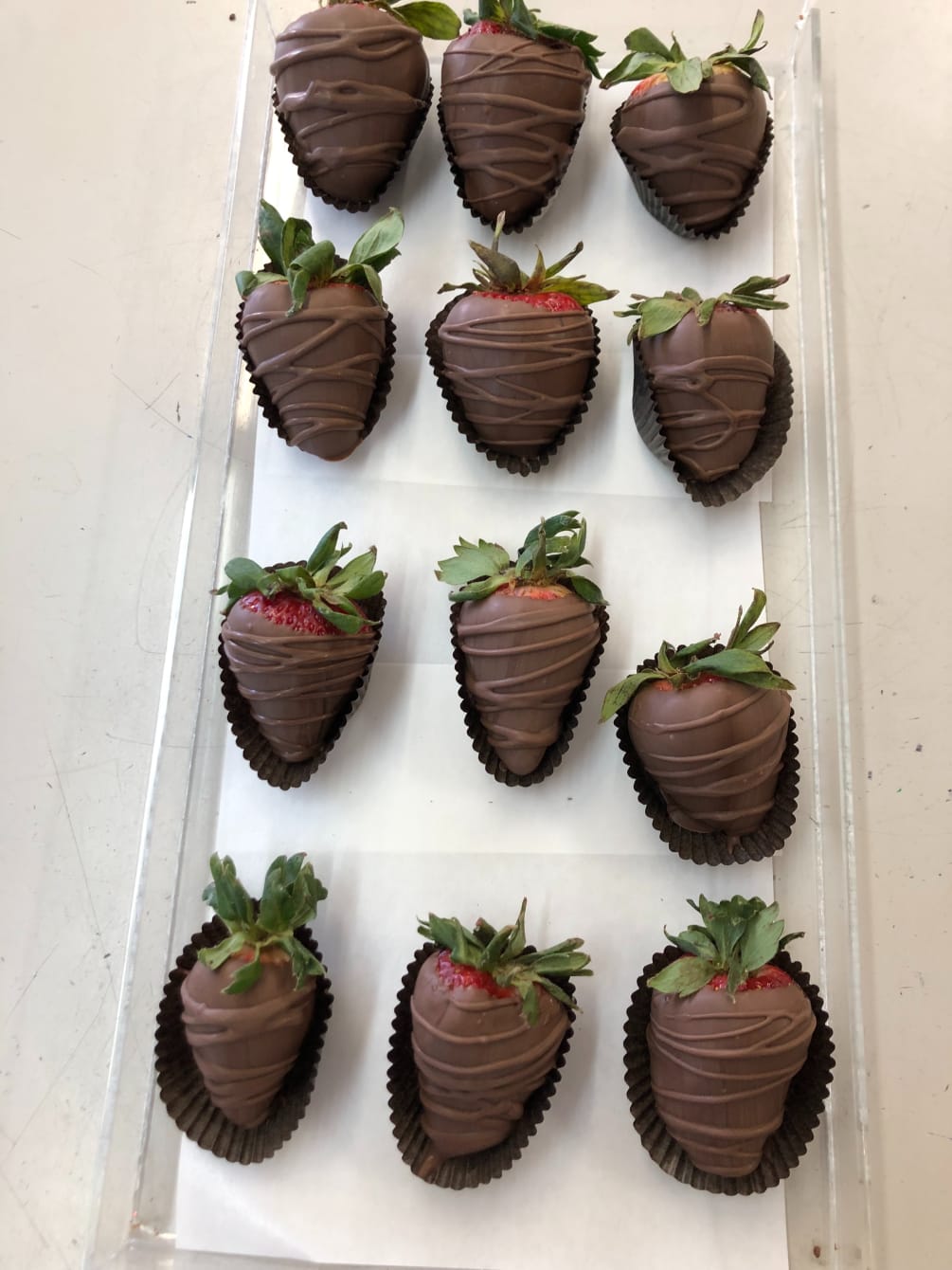 One doze delicious hand-dipped strawberries in milk chocolate. 