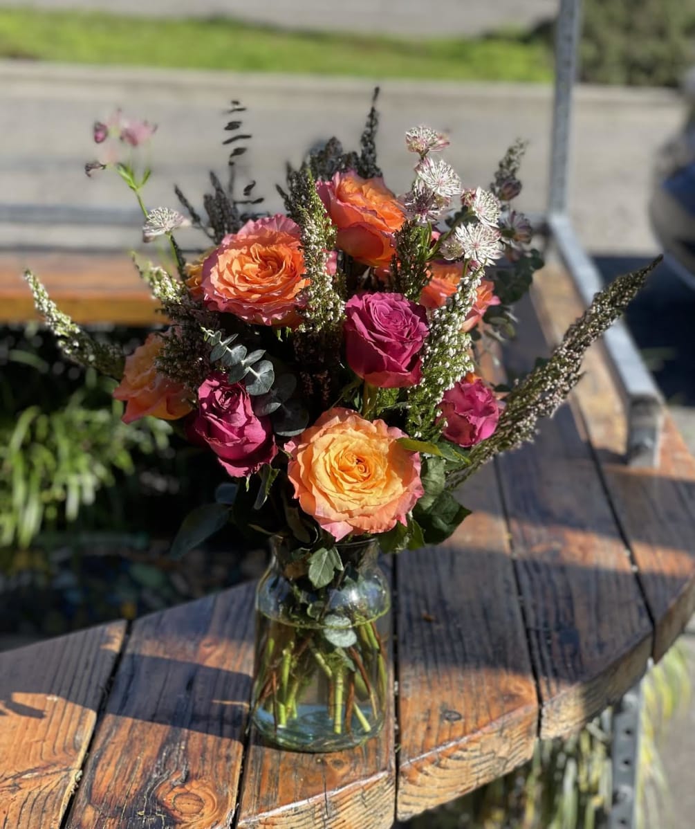 Show someone some love with this vase arrangement featuring roses and other