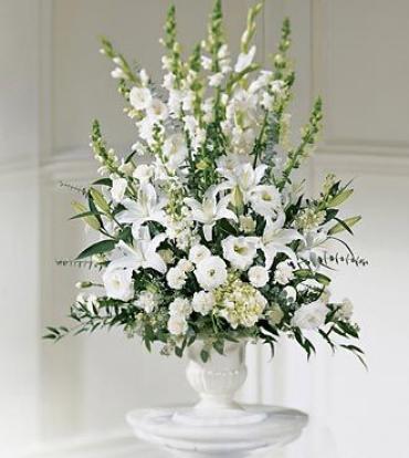 A brilliant display of white flowers to send your condolences. White lilies