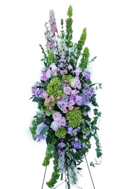 A beautiful easel spray in peaceful pastel tones featuring green hydrangea, larkspur
