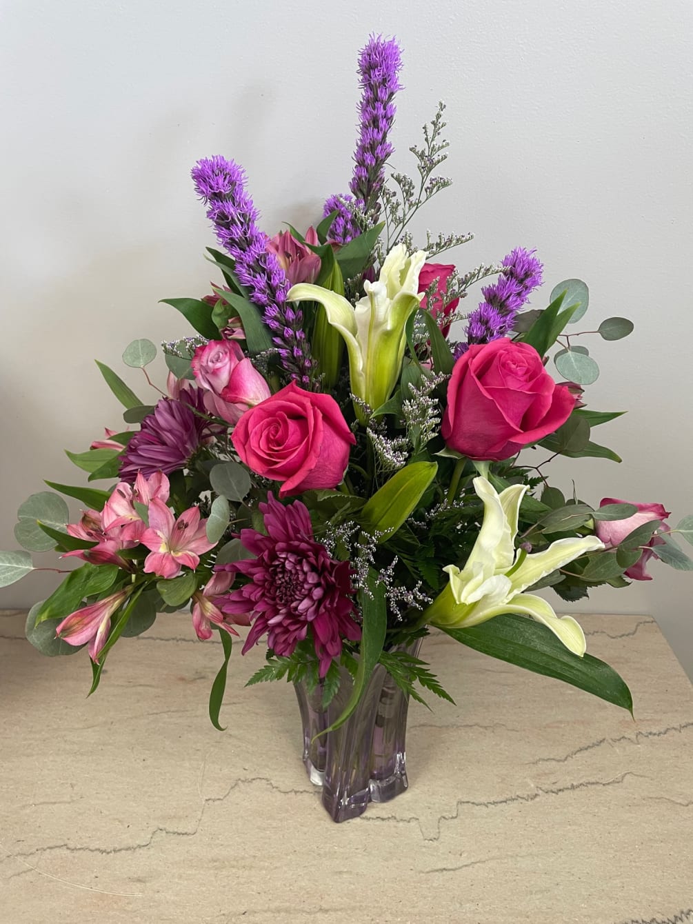 A gorgeous collection of fragrant favorites-Lilies and roses accented with a lovely