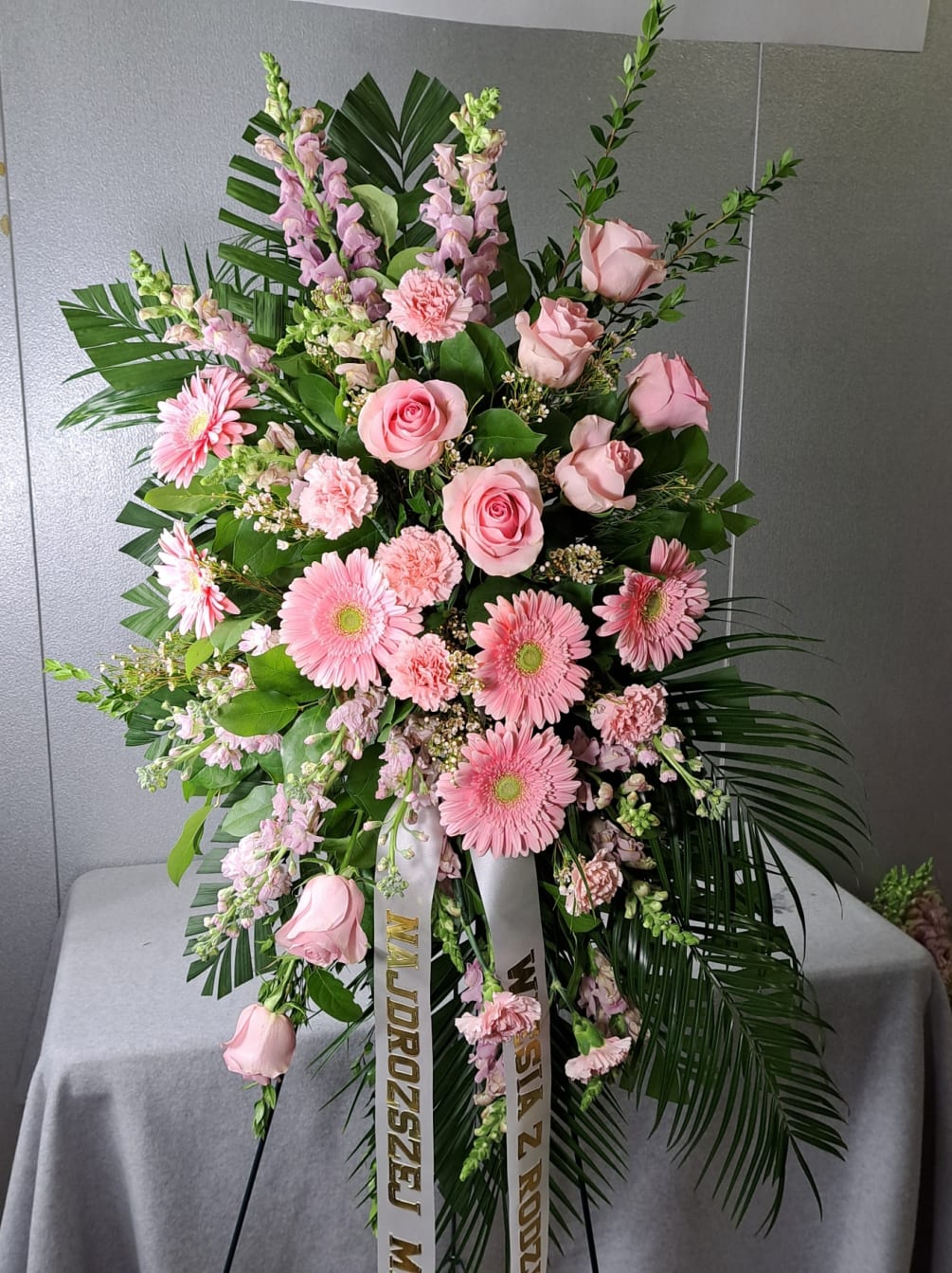 This traditional standing spray is arranged with pink gerbera daisies, roses, carnations