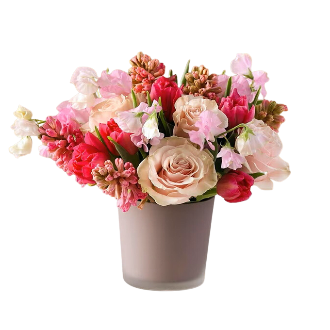 A mixture of pink and peach springtime flowers with fillers and greens.