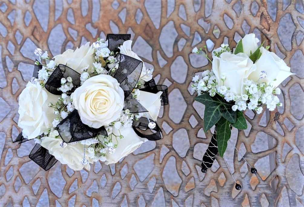 Shown as Standard
White spray roses, babies breath, gems and black ribbon come