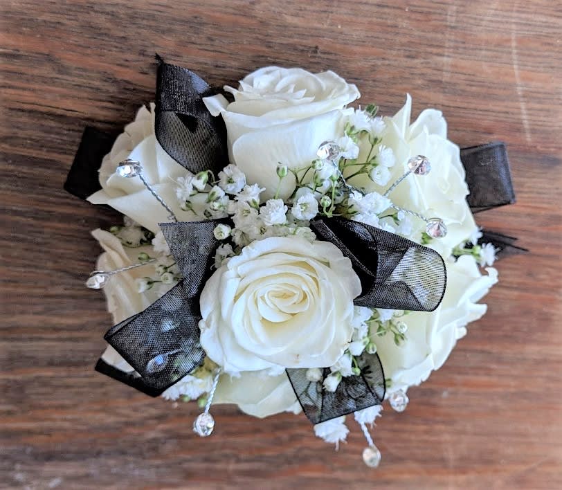 Shown as Standard
White spray roses, babies breath, gems and black ribbon come
