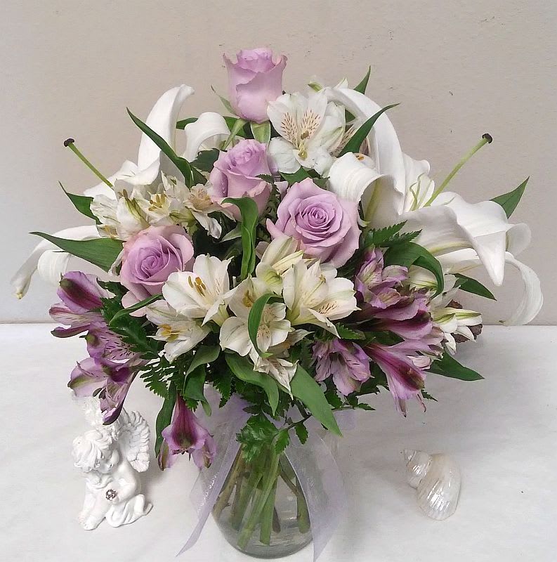 Stunning lavender roses are blended with alstromeria and lilies to highlight this