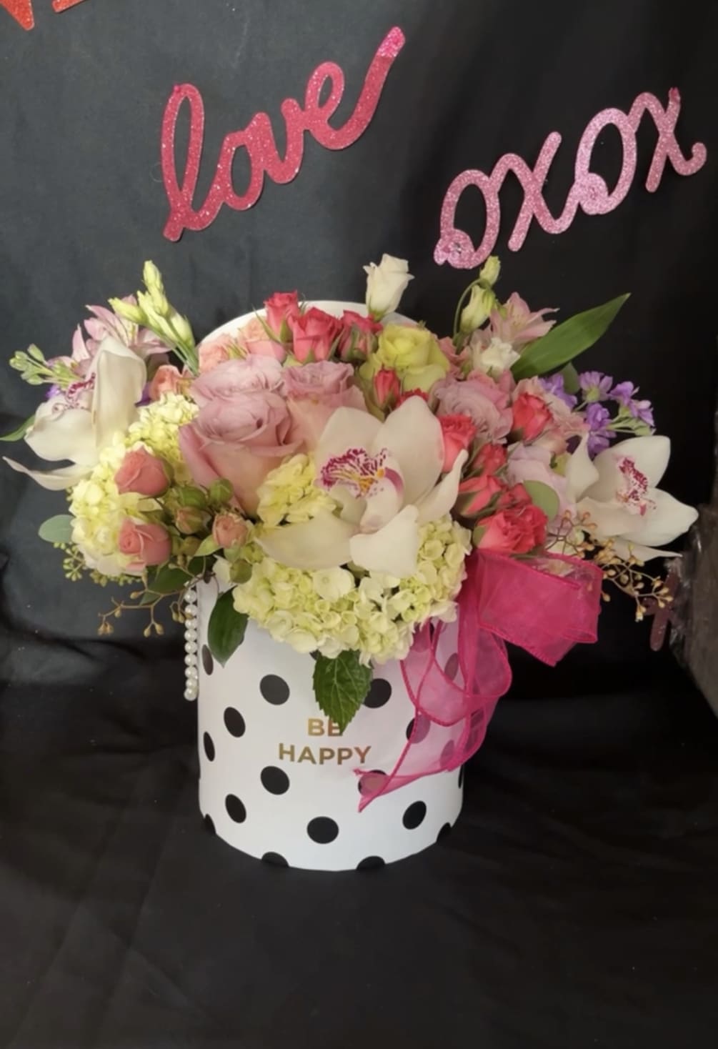 Tall cylinder box filled with a color mix of Roses, Orchids, Hydrangeas