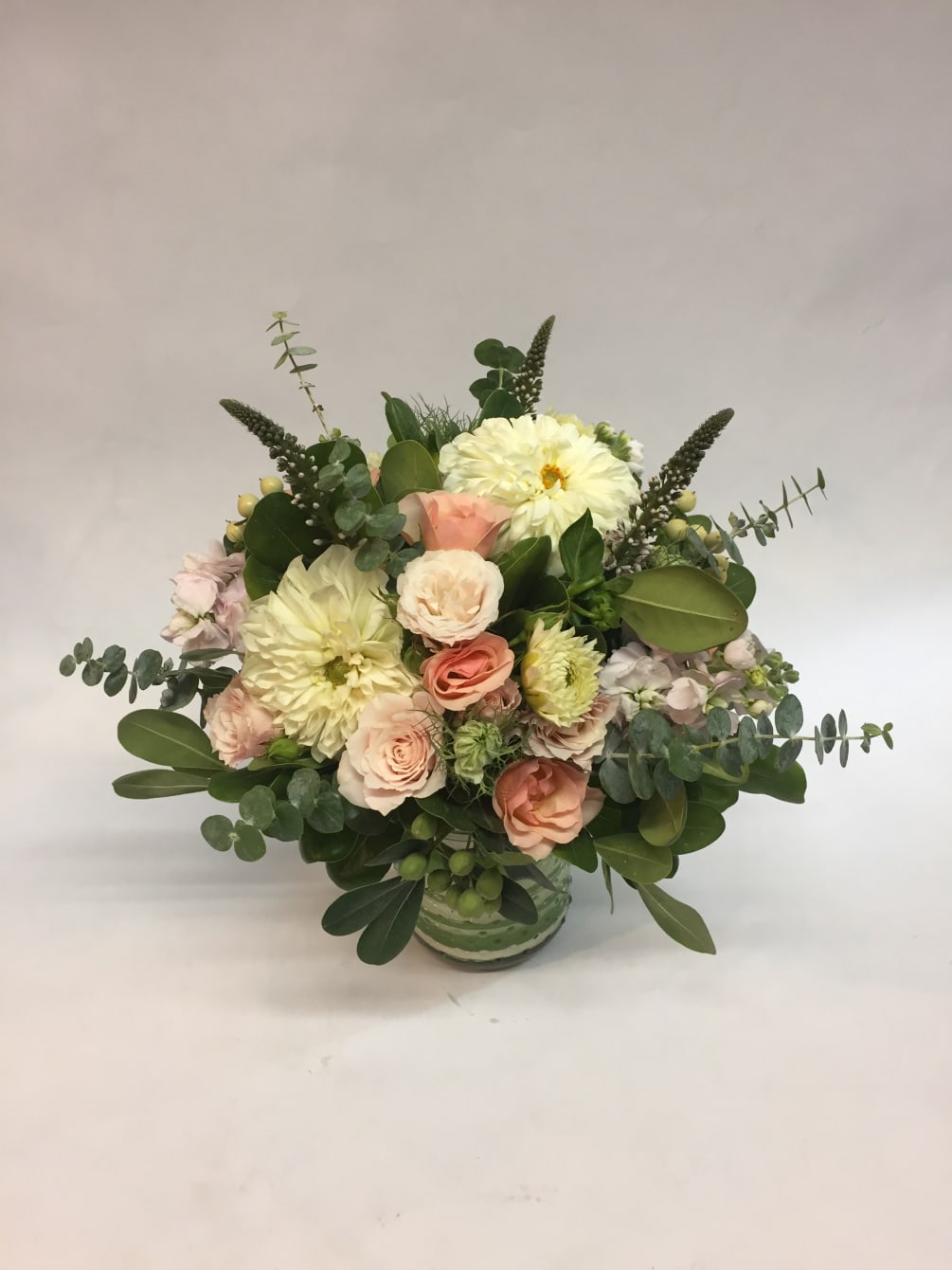 This low arrangement comes complete with light pink spray roses, white dahlias