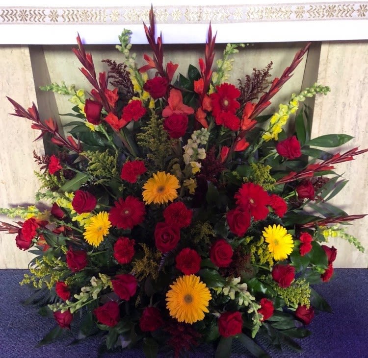 Funeral basket with deep colors of red orange and yellow