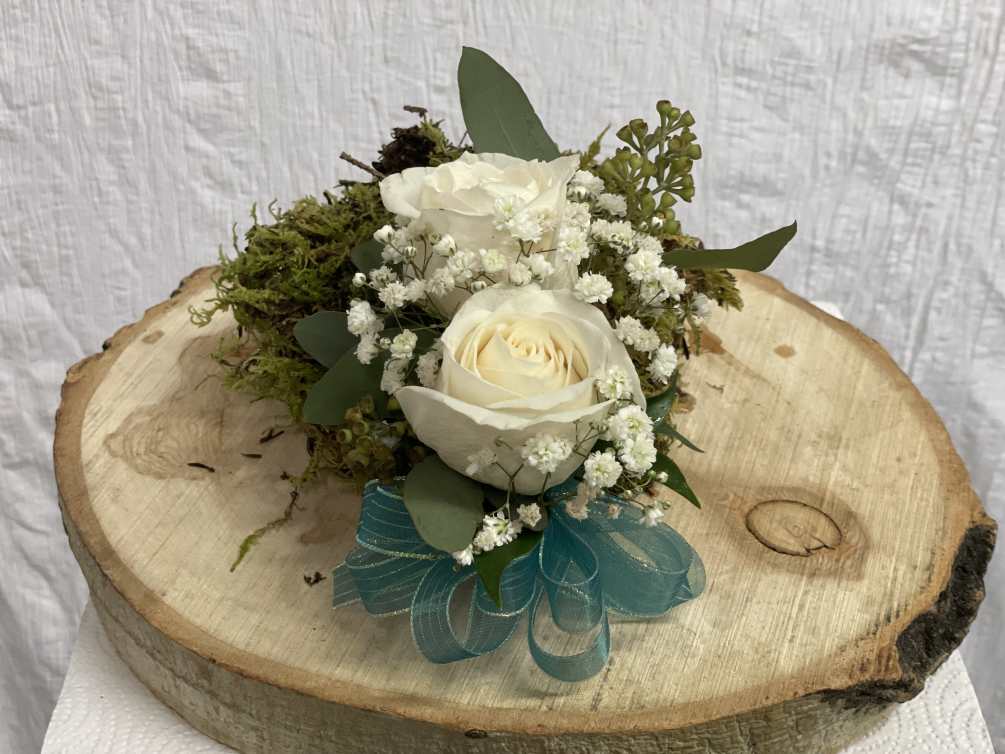 Two roses wrist corsage with baby&#039;s breath, green and a bow. Bow