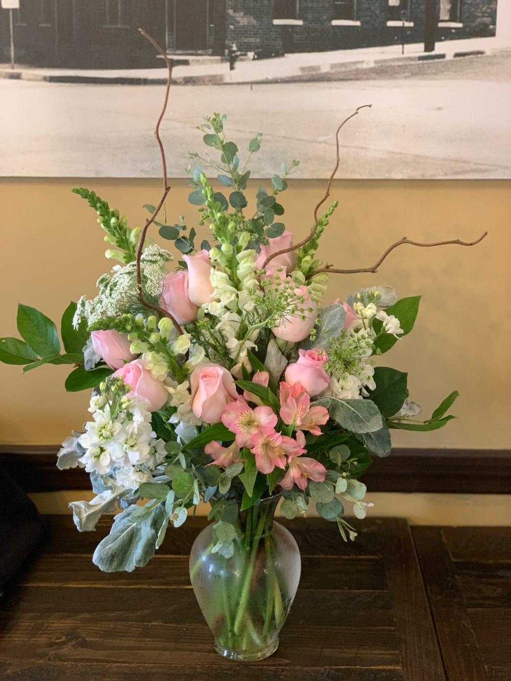 A beautiful arrangement in soft pink and white flowers such as, roses