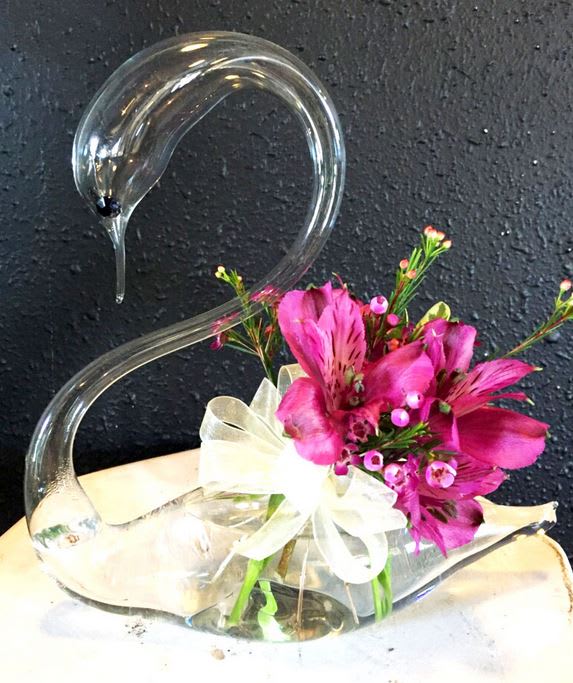 This delightful hand-blown glass vase with floral arrangement is the perfect touch