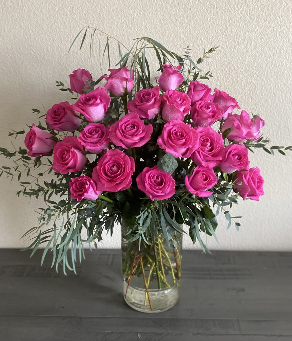 Two dozen beautifully arranged pink roses. 