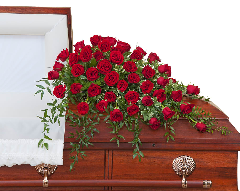 An abundance of Red roses with premium foliage in a casket spray.