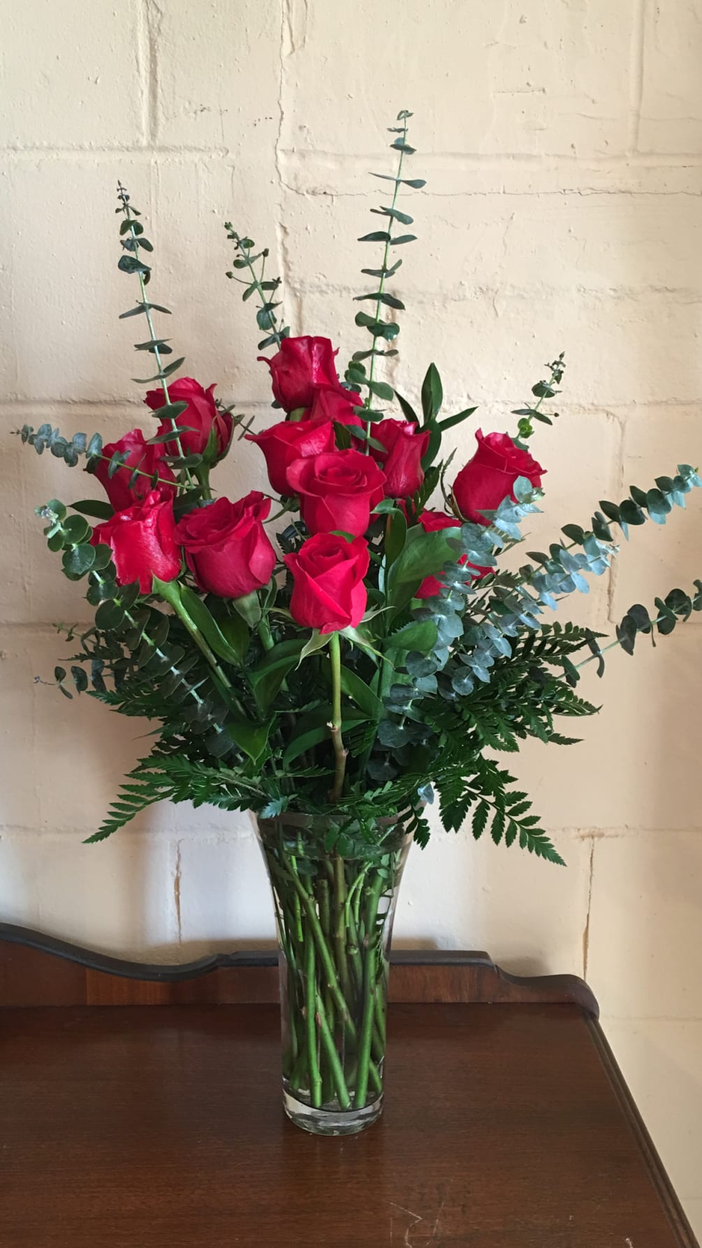 Dozen red roses in a beautiful luxury vase