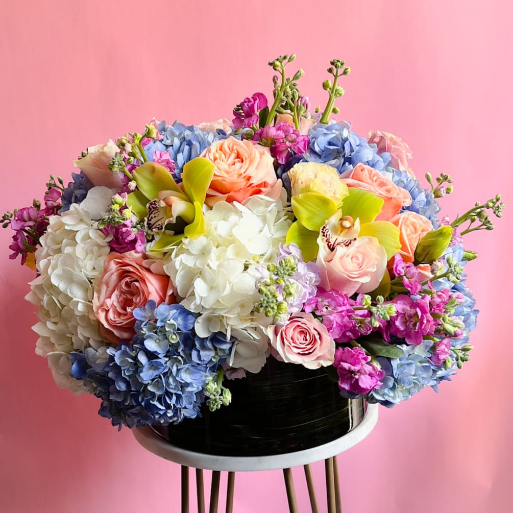 This stunning low and wide flower arrangement is perfect for any celebration.