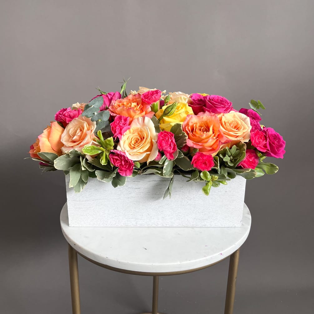 A stunning  flower arrangement features a mix of peach, orange and