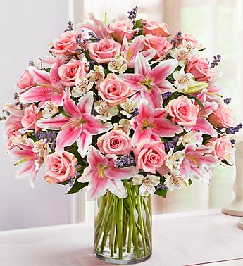 A large, elegant vase of all shades of pinks and some whites