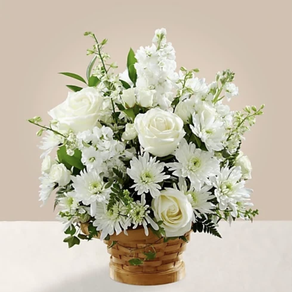 Let this exquisite composition of beautiful white blossoms deliver your sympathy and