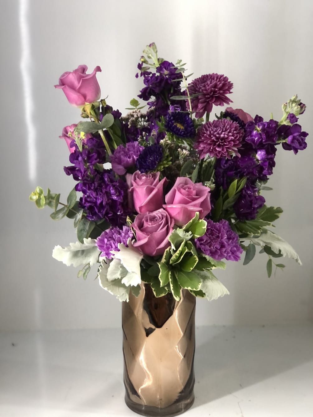 All lavender and purple blooms! In a classy gold vase (May change