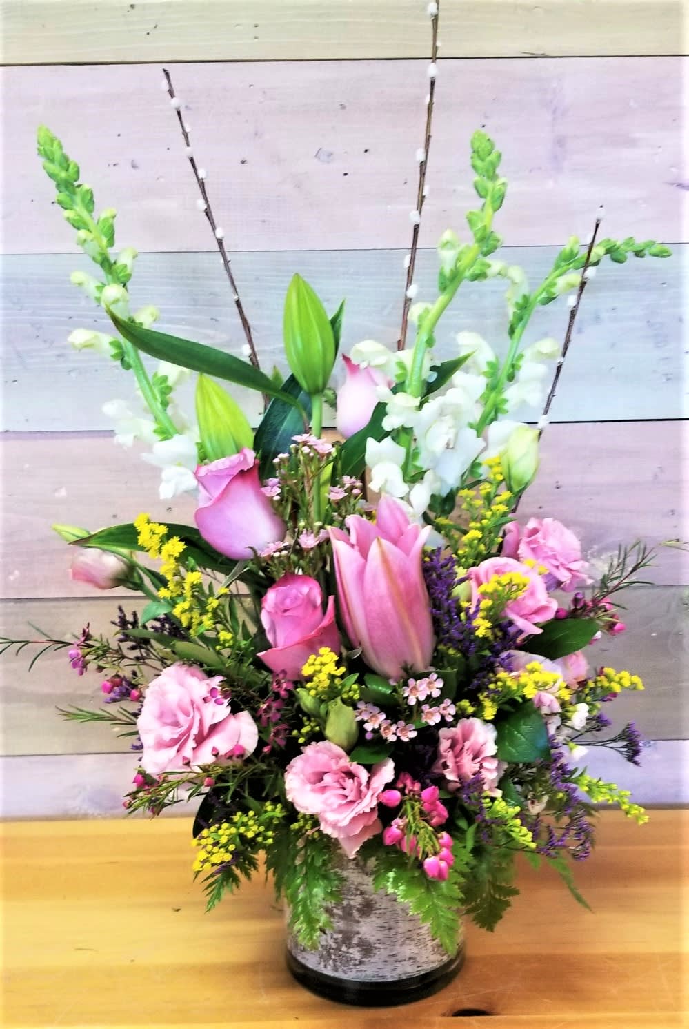 A peaceful arrangement of  Pink Roses, Lilies,Snapdragons...flowers and color may vary