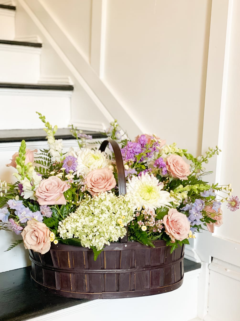 Woven Basket filled with hydrangea, mums, delphinium, roses, snapdragons and other blooms