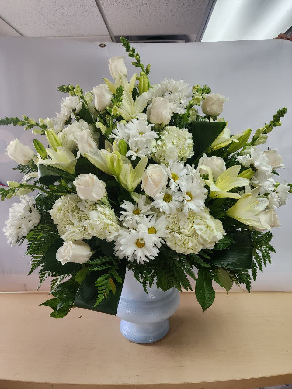 nice arrangement  with 11 white roses, 4 white hydrangeas,7white  snap