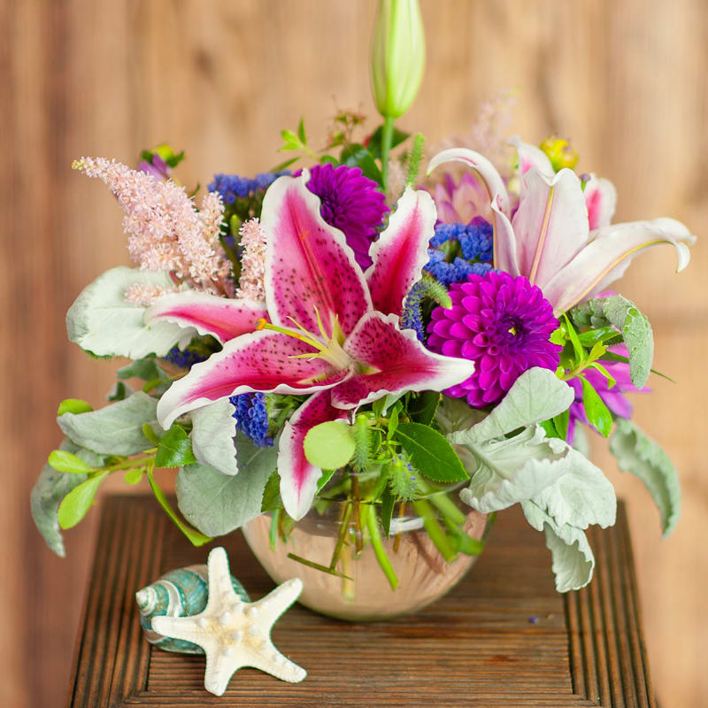 A summer-inspired design.  A bubble bowl vase gathers lilies, dahlias, astilbe