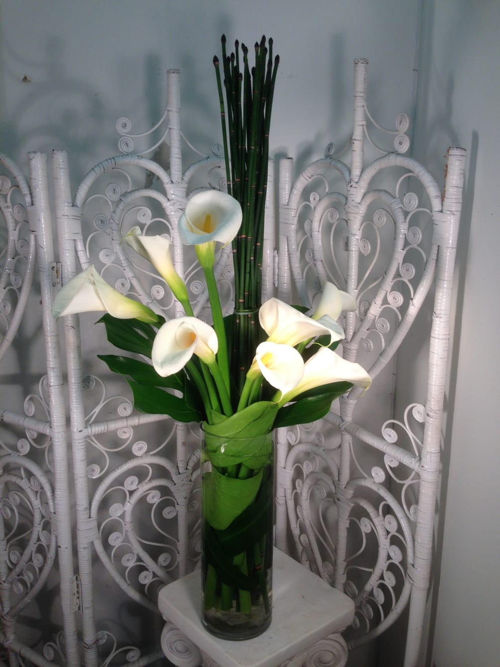 Tall, expressive and beautiful calla lilies arranged with unique greenery and horsetail